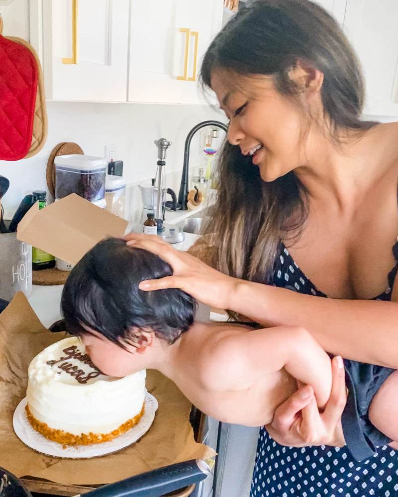 baby getting face smash in cake